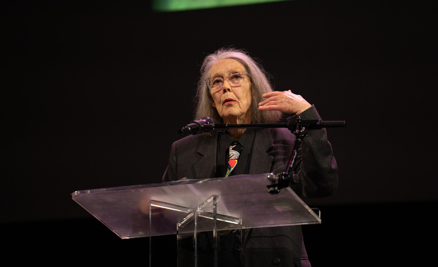 Anne Carson reads on stage at the 2024 National Book Awards finalist event
