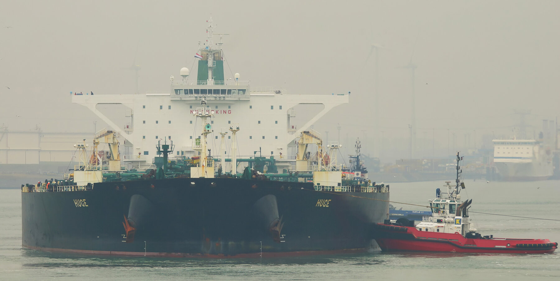 Iranian crude oil tanker Huge arriving in Rotterdam with a tugboat