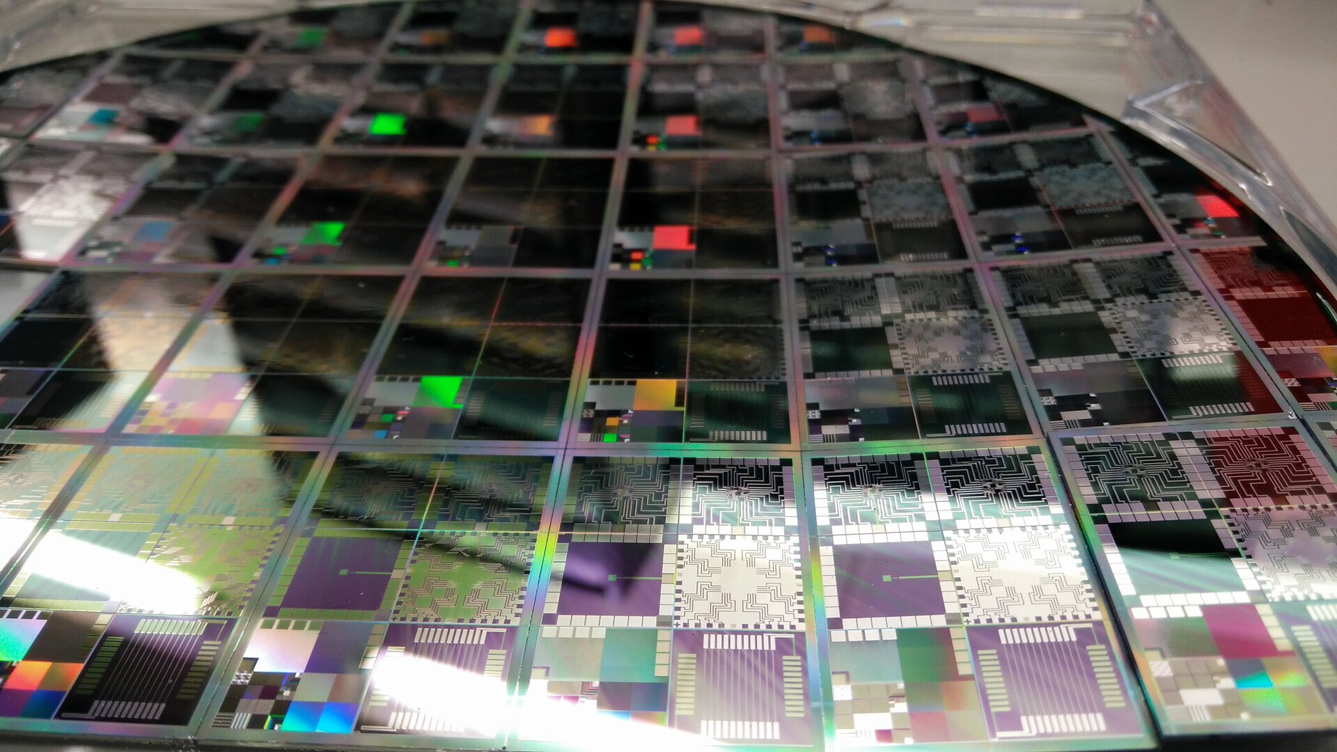 Close view of patterned semiconductor dies on a silicon wafer
